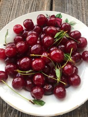 Ripe cherries in a white plate macro