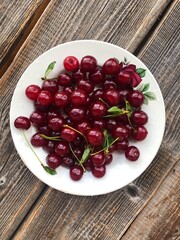 Ripe cherries in a white plate macro