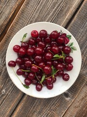 Ripe cherries in a white plate macro