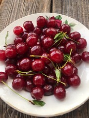 Ripe cherries in a white plate macro
