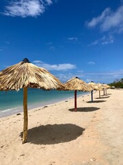 Peaceful and relaxing travel destination in Cuba (Caribbean): Dreamlike Playa Ancon with white sand, turquoise ocean and blue sky is an idyllic vacation paradise