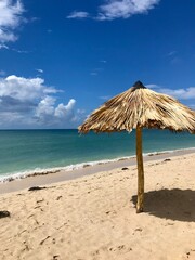 Peaceful and relaxing travel destination in Cuba (Caribbean): Dreamlike Playa Ancon with white sand, turquoise ocean and blue sky is an idyllic vacation paradise