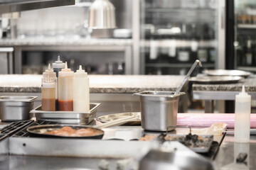 Food being cooked in commercial stainless steel kitchen in restaurant. High quality photo