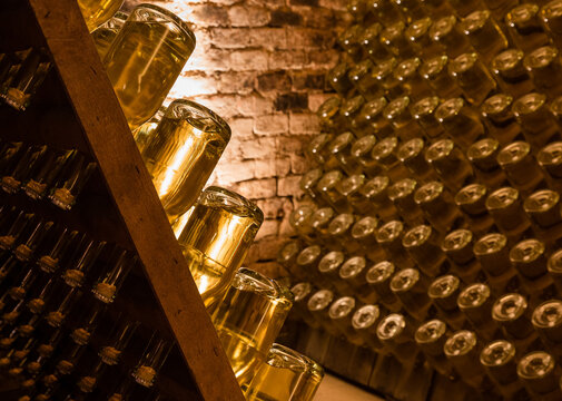 Sparkling Wine Bottles Stored During Maturing And Fermentation In A Cellar