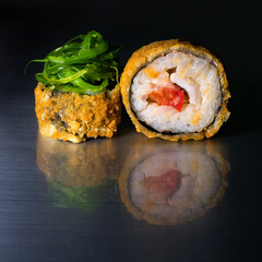 Spicy roll of rice and nori seaweed with breaded seaweed on a dark background with reflection