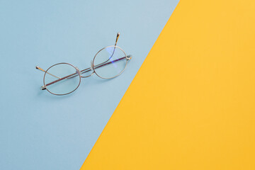 Eyeglasses desk concept mustard yellow and celeste blue ready for poster add text mock up