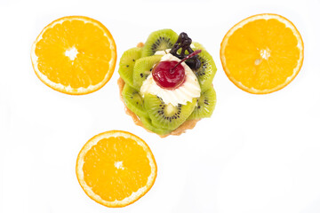 Cake with kiwi cherries and custard, near slices orange. White background,