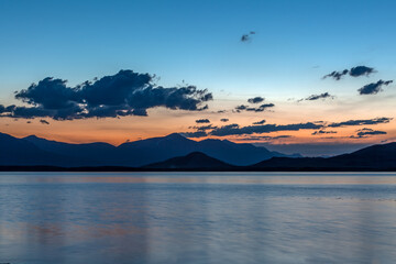 Mountain landscape at sunset. Outstanding view of the mountain ridges and clouds. Mountain Lake in Altai of Mongolia