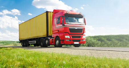 European Truck  with container on highway and blue sky with  clouds. Cargo transportation concept. 