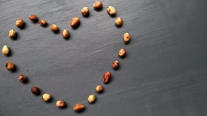 Heart / love shape character made from bambara groundnut with gray background
