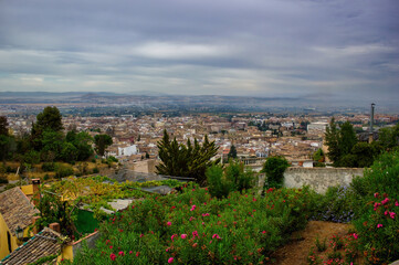 Obraz premium Beautiful wide angle scenic view of Granada city located in southern Spain, Andalusia against dramatic clouds, Europe