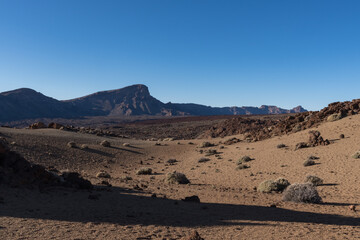 Martian landscape on the eastern slopes of Montana Blanca Mirador las Minas de San Jose with Teide mount at background. Teide National park, Tenerife, Canary islands, Spain