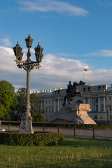Fototapeta premium The Bronze Horseman is an equestrian statue of Peter the Great in the Senate Square. Building of Constitutional Court of the Russian Federation at the background. Saint Petersburg, Russia