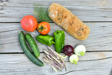 Various types of vegetable and some tools placed on wooden board
