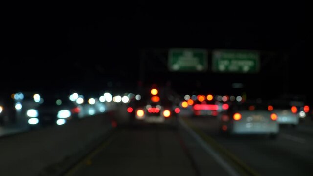 Blur bokeh Night traffic a lot of cars driving slowly with lights on