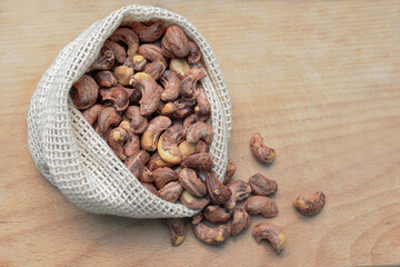Сashew nuts in an eco-friendly bag on the kitchen board