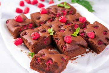Homemade dark chocolate brownies with raspberries with fresh raspberries, mint