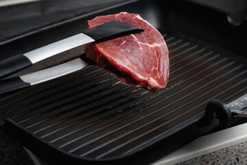 Raw aged Angus steak, fried in a cast-iron pan. Fluted frying pan.