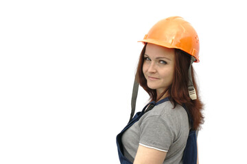 A woman in a construction helmet and work clothes stands half a turn on a white background with place for text