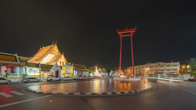 Time lapse. The Giant Swing or Sao Ching Cha monument with Wat Suthat temple at night in old town, Bangkok City, Thailand. Landmark tourist attraction. Thai architecture with travel trip concept.