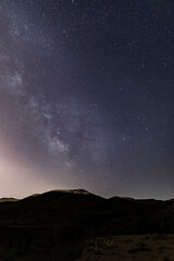 The milky way over the canyon in the desert