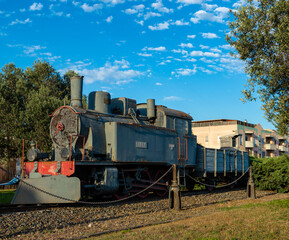 Fototapeta na wymiar Monserrato, Sardinia, Italy - 07/23/2020: Old Italian Locomotive Giara built by Ernesto Breda in 1917 with cloudy sky in background