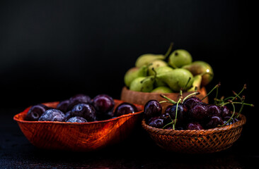 Various fruits on black background