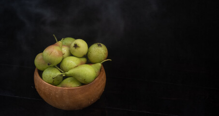 Ripe pear on black background