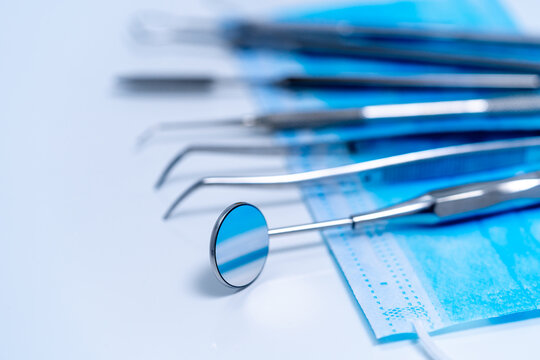 Dental treatment concept. Metal stomatology instruments. Closeup.
