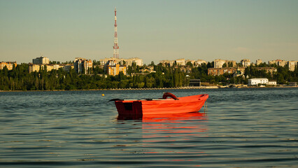 City view of Mykolaiv, Ukraine. Red boat of rescue team ready for recovery from the river
