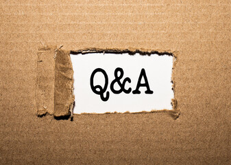 The text Q and A. behind torn brown paper