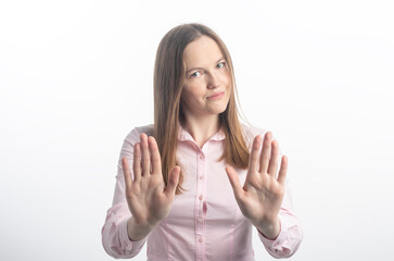 woman gesturing stop or saying no with a smile, with flirt and coquetry, extending her hands palms...