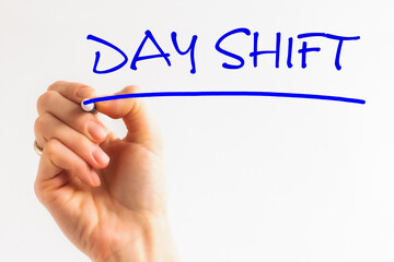 Hand writing DAY SHIFT with blue marker on transparent wipe board. Day shift word in a dictionary. day shift concept