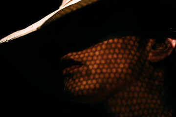 Portrait of beautiful girl in hat in profile, posing in studio