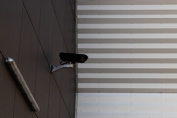 Surveillance camera on the outside wall of a building symbolizing state supervision