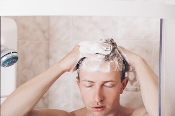 Shower man washing hair rinsing shampoo in bathroom