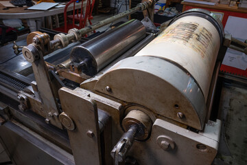 Antique press in use in a print shop