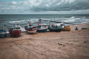 Fototapeta premium At Beach of Jaroslawiec in Poland fishing boats lie on the beach of the Baltic Sea