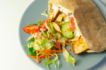 Mediterranean style pitta prepared with spicy chicken, cucumber, tomato, salad and mayo sauce