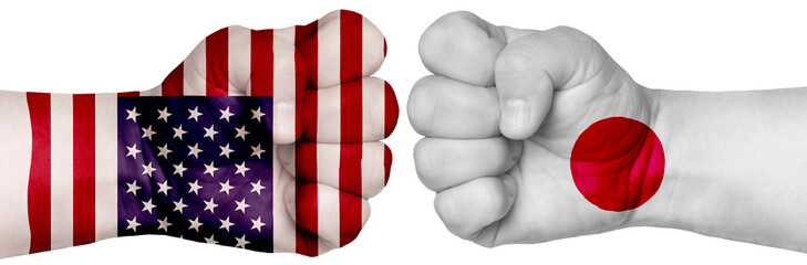 Two hands are clenched into fists and are located opposite each other. Hands painted in the colors of the flags of the countries. Japan vs USA