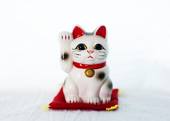 Japanese cat figure also known as Maneki-neko. Symbolizing luck and wealth. (Money cat. Fortune cat.Welcoming cat.)
