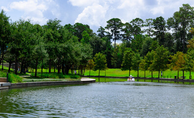 the Woodlands Waterway with swan paddle boat in background