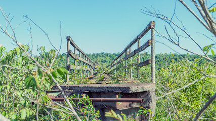 Viejo puente peatonal en desuso sobre el río