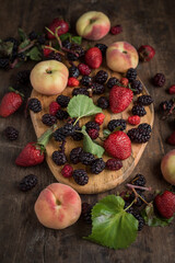 summer fruits and berries on wooden board