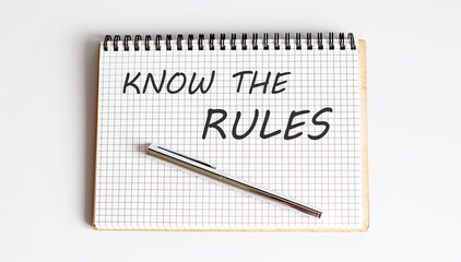 Know The Rules text written on a notebook with pen