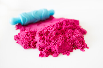 Pink kinetic sand with rolling pin. games, education, children room