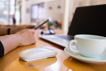 Businessmen are searching for information from the internet on a notebook computer to publicize the marketing work for the company to send sales.