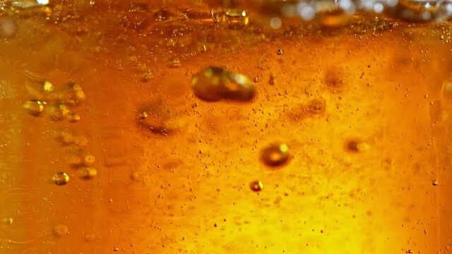 Super Slow Motion Detail Shot of Beer Bubbles in Glass at 1000fps.