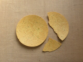 Whole and broken yellow color Khakhra Indian savory snack