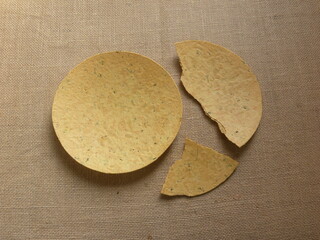 Whole and broken yellow color Khakhra Indian savory snack